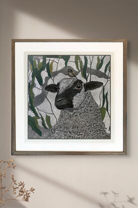 A framed mixed media drawing of a Sheep and a Little Brown Bird amongst eucalyptus on 360 gsm pastel paper, rendered in coloured pencil and oil pastel