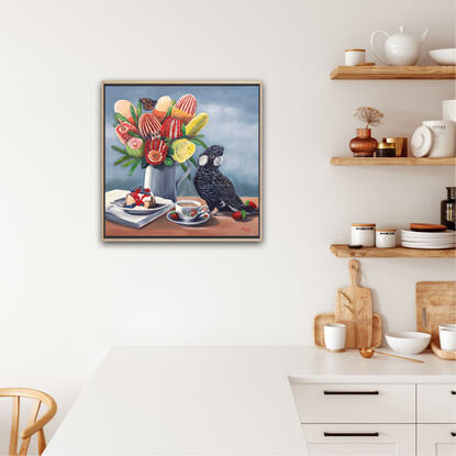 Carnaby's Cockatoo and banksias and cake on a table top. 