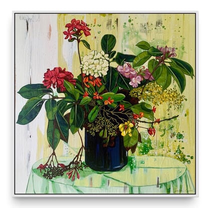 A framed limited edition canvas print in a white wood floating frame of an original still life painting of flowers in yellows, greens , reds and oranges in a glass vase