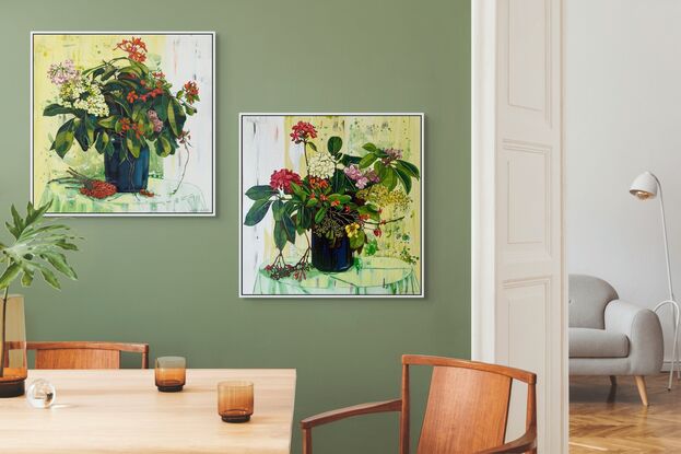 A framed limited edition canvas print in a white wood floating frame of an original still life painting of flowers in yellows, greens , reds and oranges in a glass vase