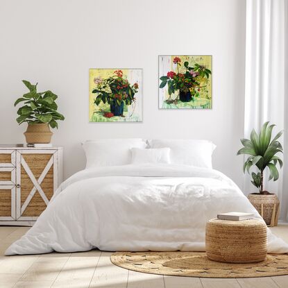 A framed limited edition canvas print in a white wood floating frame of an original still life painting of flowers in yellows, greens , reds and oranges in a glass vase