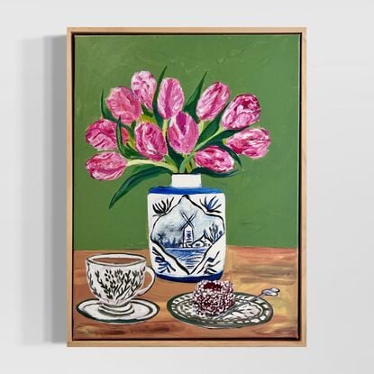 . The vase itself features a picturesque landscape of a Dutch windmill by a lakeside. Accompanying the scene is a cup of English milk tea and a delicious Lamington cake on a ceramic plate. The artwork conveys a sense of warmth and comfort, blending both Dutch and English elements seamlessly. 