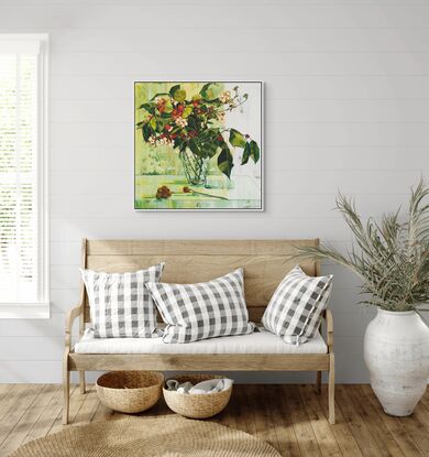 A framed limited edition canvas print in a white wood floating frame of an original still life painting of flowers in yellows, greens , reds and oranges in a glass vase