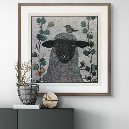 A framed mixed media drawing of a Sheep and a Little  Bird amongst eucalyptus on 360 gsm pastel paper, rendered in coloured pencil and oil pastel