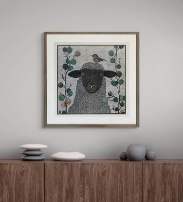 A framed mixed media drawing of a Sheep and a Little  Bird amongst eucalyptus on 360 gsm pastel paper, rendered in coloured pencil and oil pastel