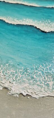 Turquoise blue waves and white wash, rolling onto the beach