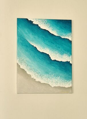 Turquoise blue waves and white wash, rolling onto the beach