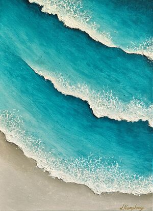 Turquoise blue waves and white wash, rolling onto the beach