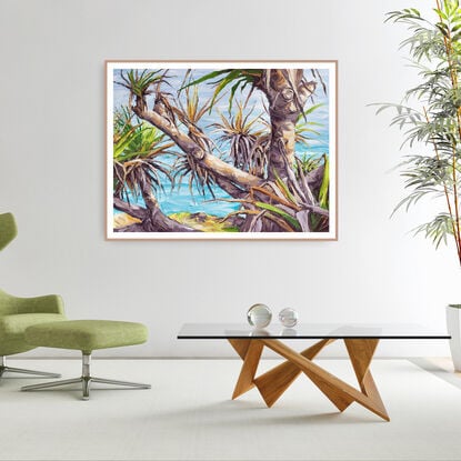 pandanus tree in late afternoon light with ocean behind