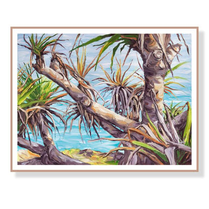 pandanus tree in late afternoon light with ocean behind