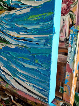 Light blue colours with ocean rocks and a bay, green hills. Painted in expressive abstract strokes. 

