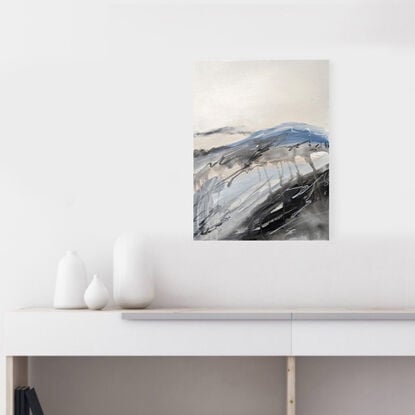 A large abstract landscape of the Victorian Alpine region in mixed media in pale blue, cream, beige and grey.