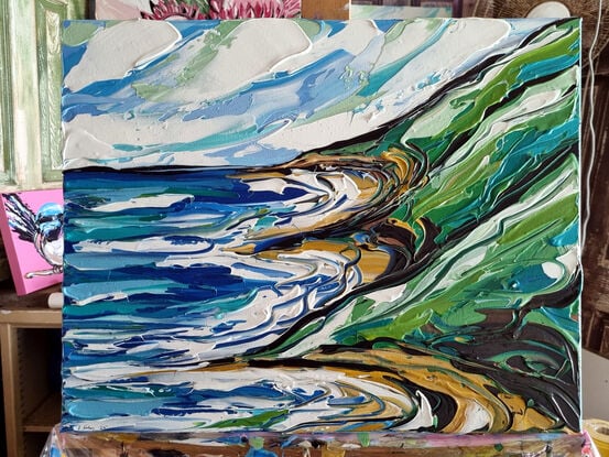 Light blue colours with ocean rocks and a bay, green hills. Painted in expressive abstract strokes. 

