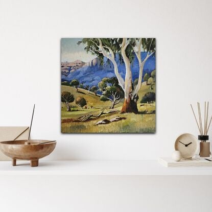 Australian Landscape depicting a gum tree against blue mountains.