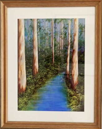 A peaceful blue stream wends its way through the stately tall karri trees in a southwest forest. The background sky peeps through the green undergrowth while the stately trees stand in solidarity along the water's edge. Bracken, ferns and ground covers frame the blueness of the water providing peaceful reflections in the slow moving stream. It is a peaceful scene to encounter.