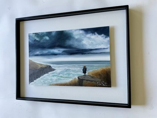 Upon the shore young boy standing and gazing horizon