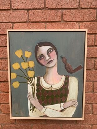 The painting depicts the head and shoulders of a girl. There is a brown bird on one shoulder of the girl. The girl is holding yellow flowers. The background is blue. 