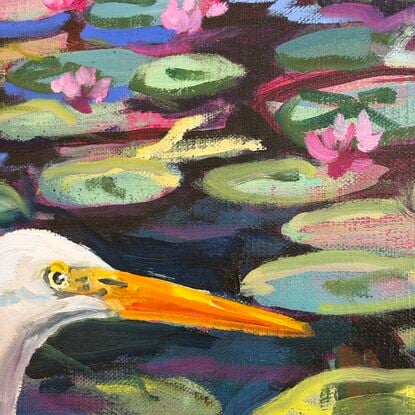 A white water bird emerges from the water of the waterlily lagoon. 