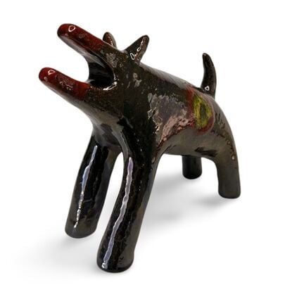 The "Raku Beast" is a striking ceramic sculpture with a glossy, dark Raku glaze that captures the untamed essence of a wild, howling creature. 
Freestanding, signed on back