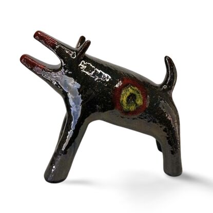 The "Raku Beast" is a striking ceramic sculpture with a glossy, dark Raku glaze that captures the untamed essence of a wild, howling creature. 
Freestanding, signed on back