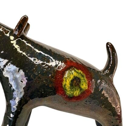 The "Raku Beast" is a striking ceramic sculpture with a glossy, dark Raku glaze that captures the untamed essence of a wild, howling creature. 
Freestanding, signed on back