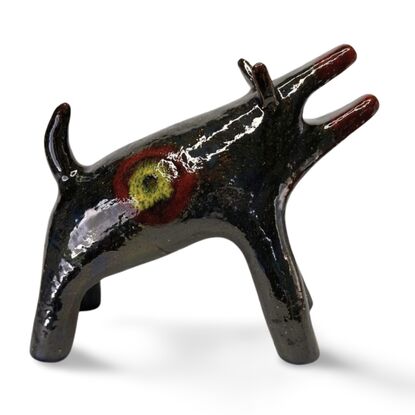 The "Raku Beast" is a striking ceramic sculpture with a glossy, dark Raku glaze that captures the untamed essence of a wild, howling creature. 
Freestanding, signed on back