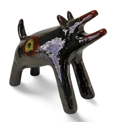 The "Raku Beast" is a striking ceramic sculpture with a glossy, dark Raku glaze that captures the untamed essence of a wild, howling creature. 
Freestanding, signed on back