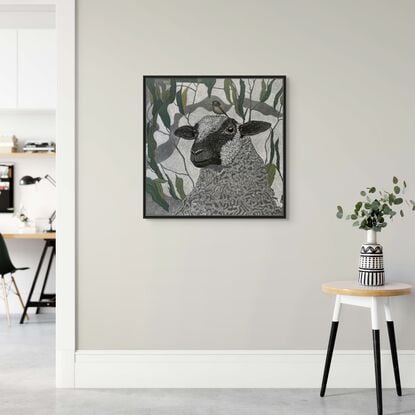 A framed  limited edition print of my mixed media drawing of a Sheep and a Little Bird amongst eucalyptus on 360 gsm pastel paper, rendered in coloured pencil and oil pastel