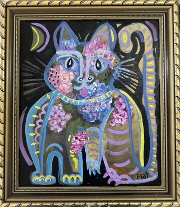 A sitting cat with hydrangea flowers in purple and blue and pink