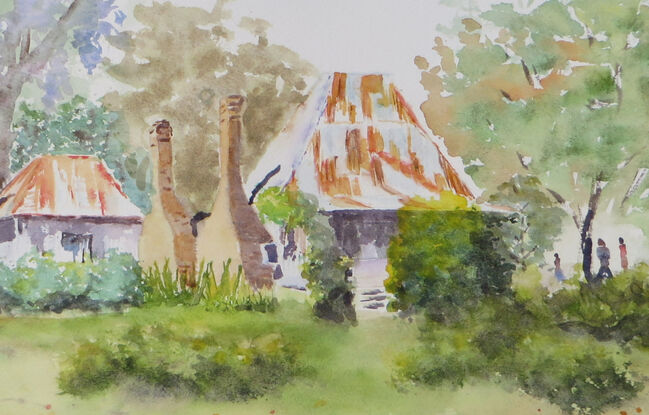 a misty spring day in the old mining village of Hill End with an old miners cottage with rusty roofs and chimney stacks surrounded by natural shrubs, grasses and trees with a hint of blooming jacaranda trees