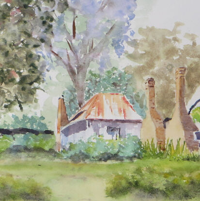 a misty spring day in the old mining village of Hill End with an old miners cottage with rusty roofs and chimney stacks surrounded by natural shrubs, grasses and trees with a hint of blooming jacaranda trees