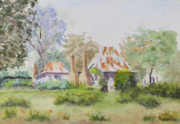 a misty spring day in the old mining village of Hill End with an old miners cottage with rusty roofs and chimney stacks surrounded by natural shrubs, grasses and trees with a hint of blooming jacaranda trees