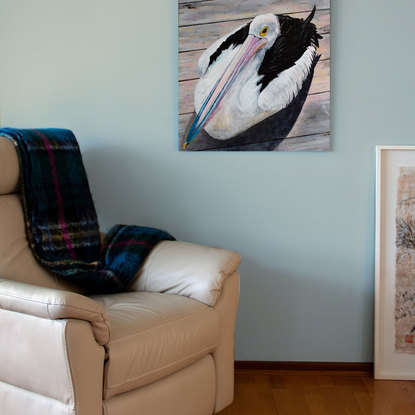 A pelican sitting on weathered wooden deck