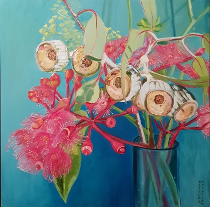 Pink gum flowers in a vase with blue background