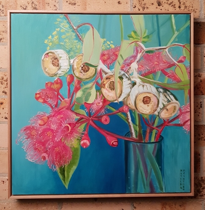 Pink gum flowers in a vase with blue background