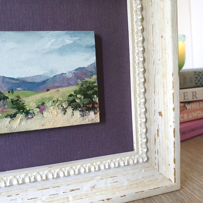 Miniature landscape of green hills with tiny cottage and Blue Mountains, oil on mini tile by Victoria Collins