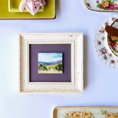 Miniature landscape of green hills with tiny cottage and Blue Mountains, oil on mini tile by Victoria Collins