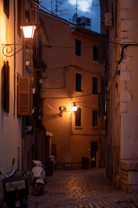 Old European cobblestone street at night