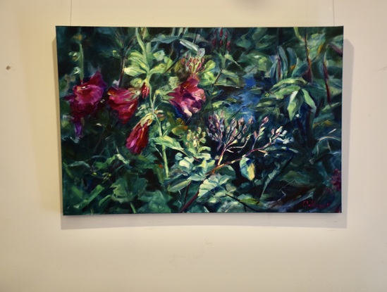 Horizontal painting of  red Hollyhock  flowers and old fashioned rose buds and a blue pond.   In a garden setting with  glimpses of a pond and a dark background