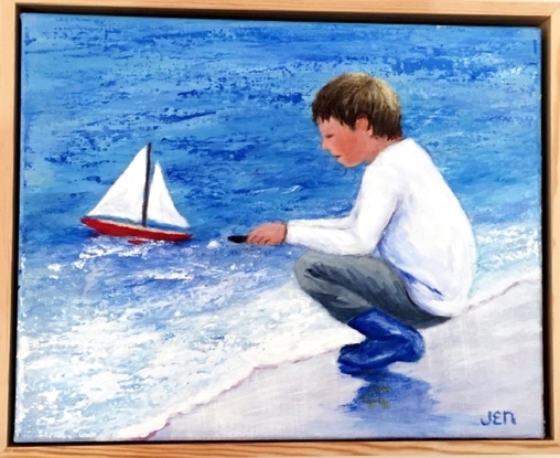 Young boy sailing his new boat for the first time. Main colours are blue and white with a touch of mauve and pink in the sand where his blue boots are reflected.