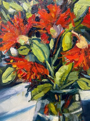 Red flowers in a vase casting shadows