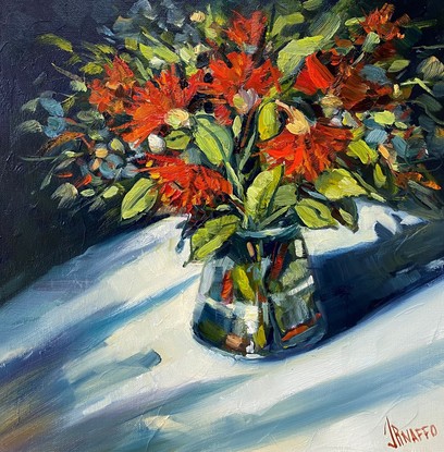 Red flowers in a vase casting shadows