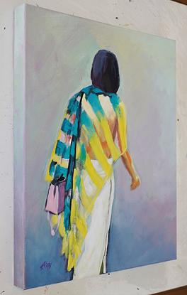 Backview of a stylish lady with a striking teal and cool lemon sheer scarf draped across her shoulders over a brilliant white fitted skirt walking near the high class shops of Florence Italy.