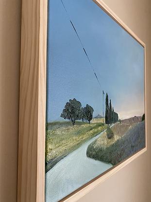 Dusk light on a farmhouse with cypress trees lining a dirt road