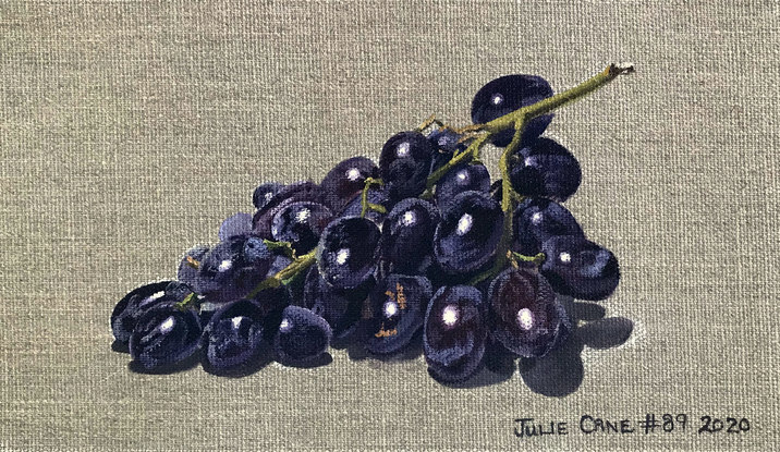 Black grapes on raw linen