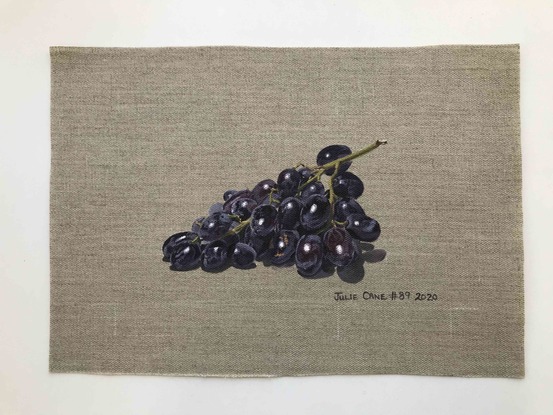 Black grapes on raw linen