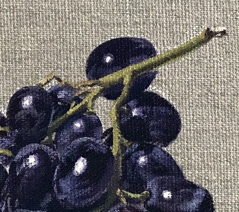 Black grapes on raw linen