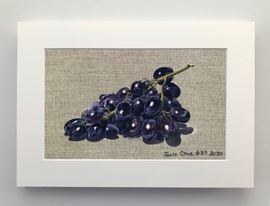 Black grapes on raw linen